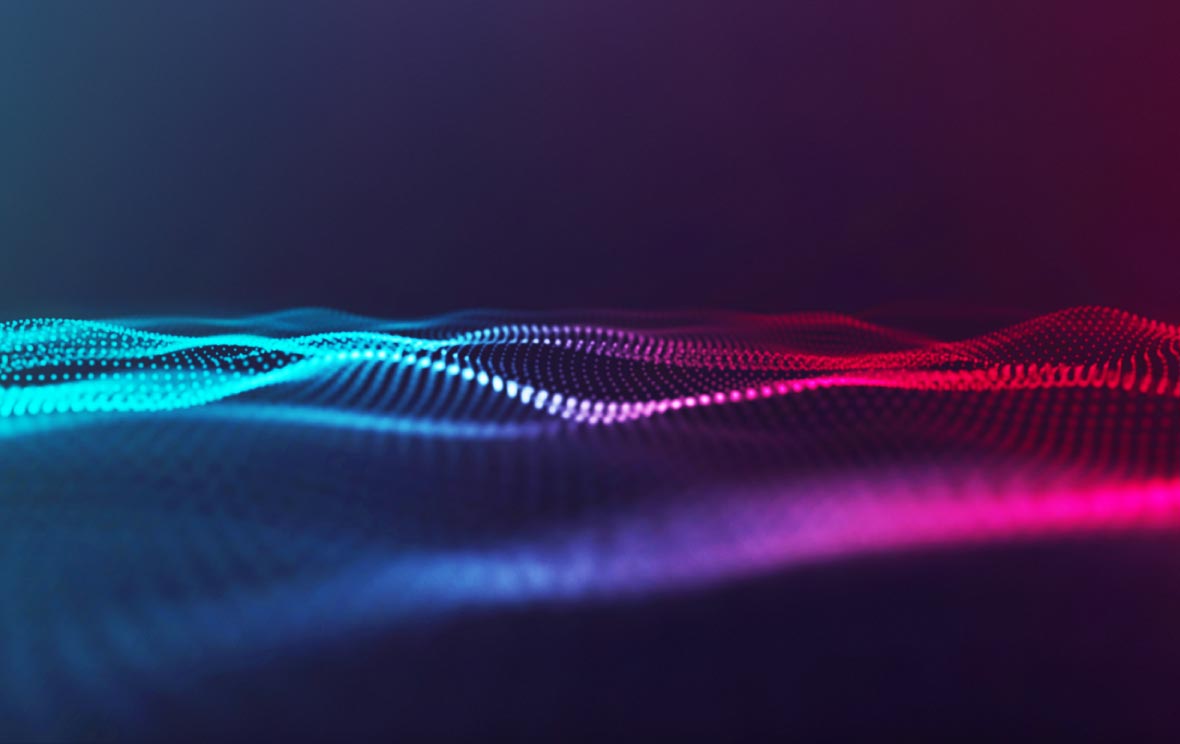 Eine abstrakte Darstellung von Wellen in leuchtenden Blau- und Rottönen. Die Struktur wirkt dynamisch und fließend, mit einem dunklen Hintergrund, der die Farben hervorhebt. Diese visuelle Komposition vermittelt ein Gefühl von Bewegung und Energie.