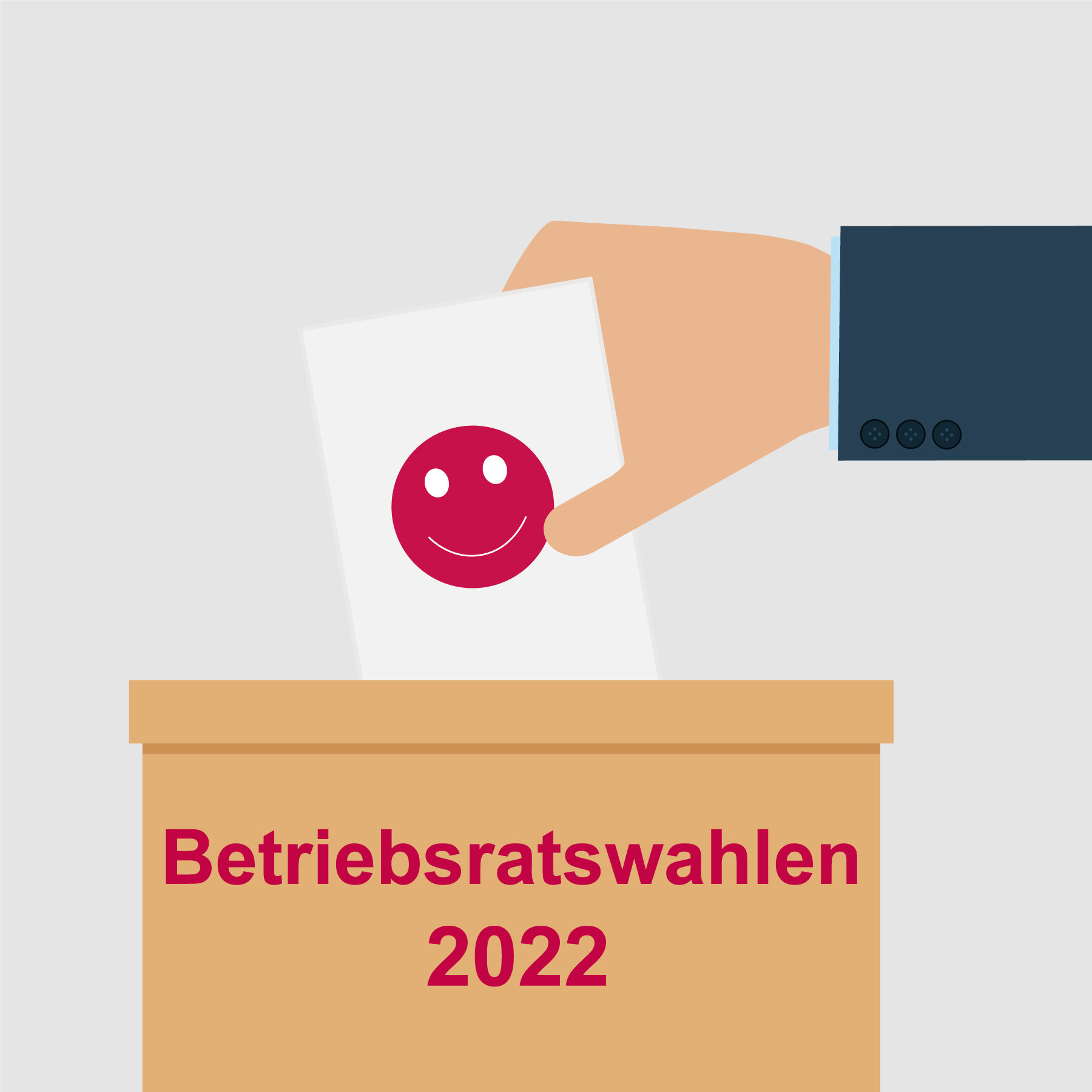 A hand places a ballot with a smiling face into a ballot box labeled "Betriebsratswahlen 2022." The image represents a voting process for an employee council election.