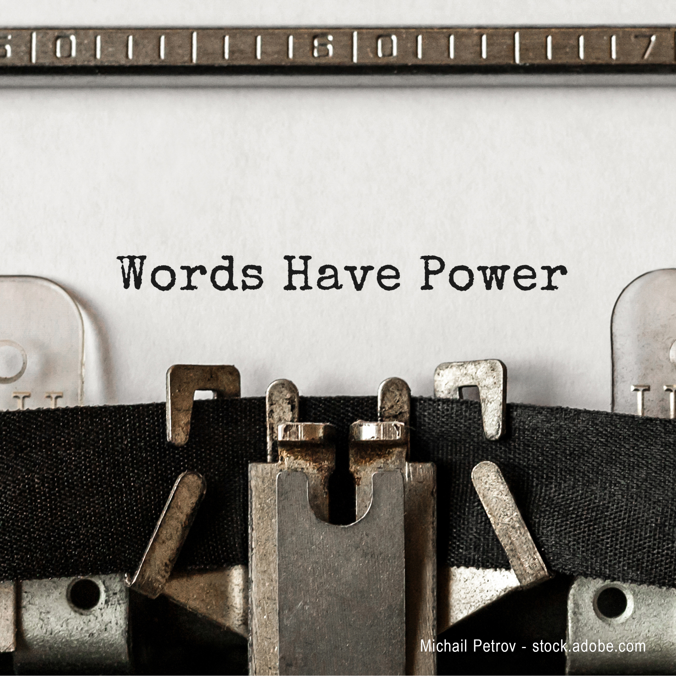 Close-up of a typewriter showing typed text that reads "Words Have Power" on a sheet of paper. The typewriter's mechanical parts and ribbon are visible, emphasizing the message about the significance of language and communication.