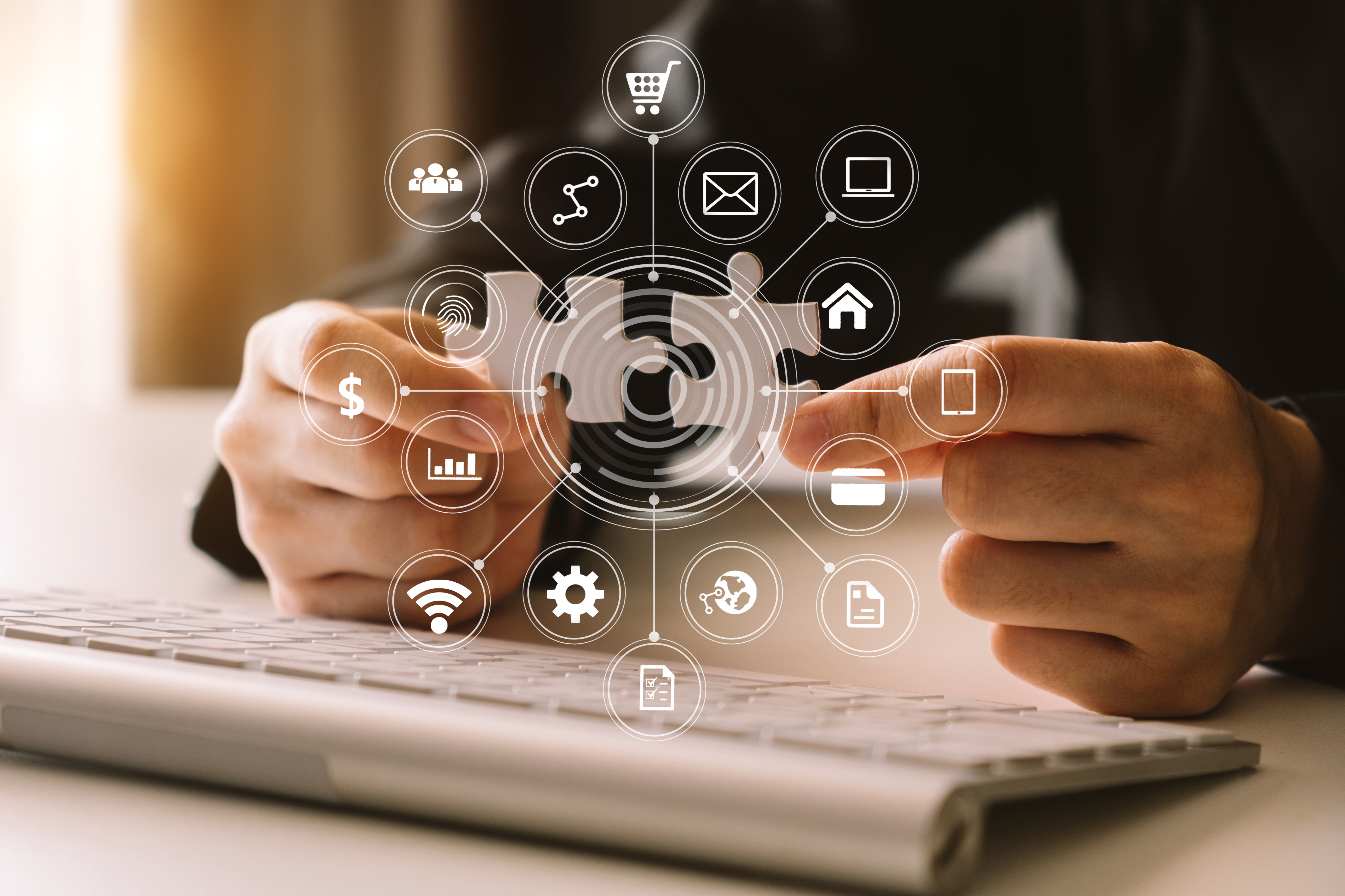 Eine Person hält ein Puzzlestück und zeigt auf verschiedene digitale Symbole, die Begriffe wie E-Commerce, Kommunikation und Analytik darstellen. Im Hintergrund ist eine Computertastatur zu sehen. Das Bild vermittelt das Thema digitale Vernetzung und Datenmanagement.