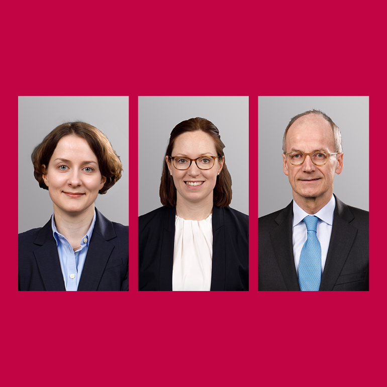 Three professional headshots of individuals are displayed in a row. The first person has short curly hair and wears a dark suit. The second person has longer hair, is smiling, and wears glasses with a black jacket. The third individual has short hair, glasses, and a suit with a light blue tie. The background is a solid color.