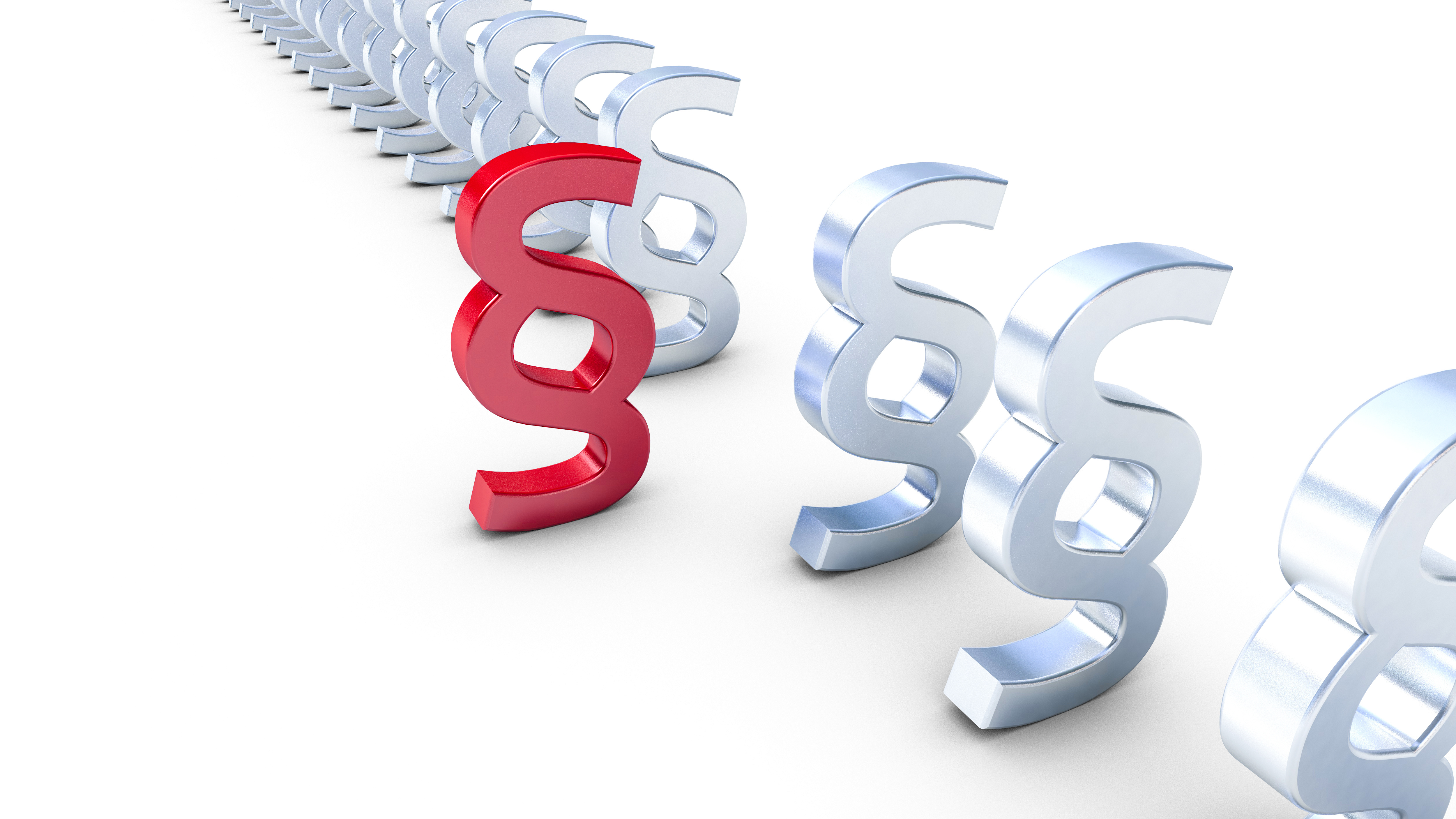 The image features a series of metallic legal symbols, with one symbol highlighted in red. The red symbol stands out against the silver ones, emphasizing its importance. This image symbolizes legal significance or a focal point in legal discussions.