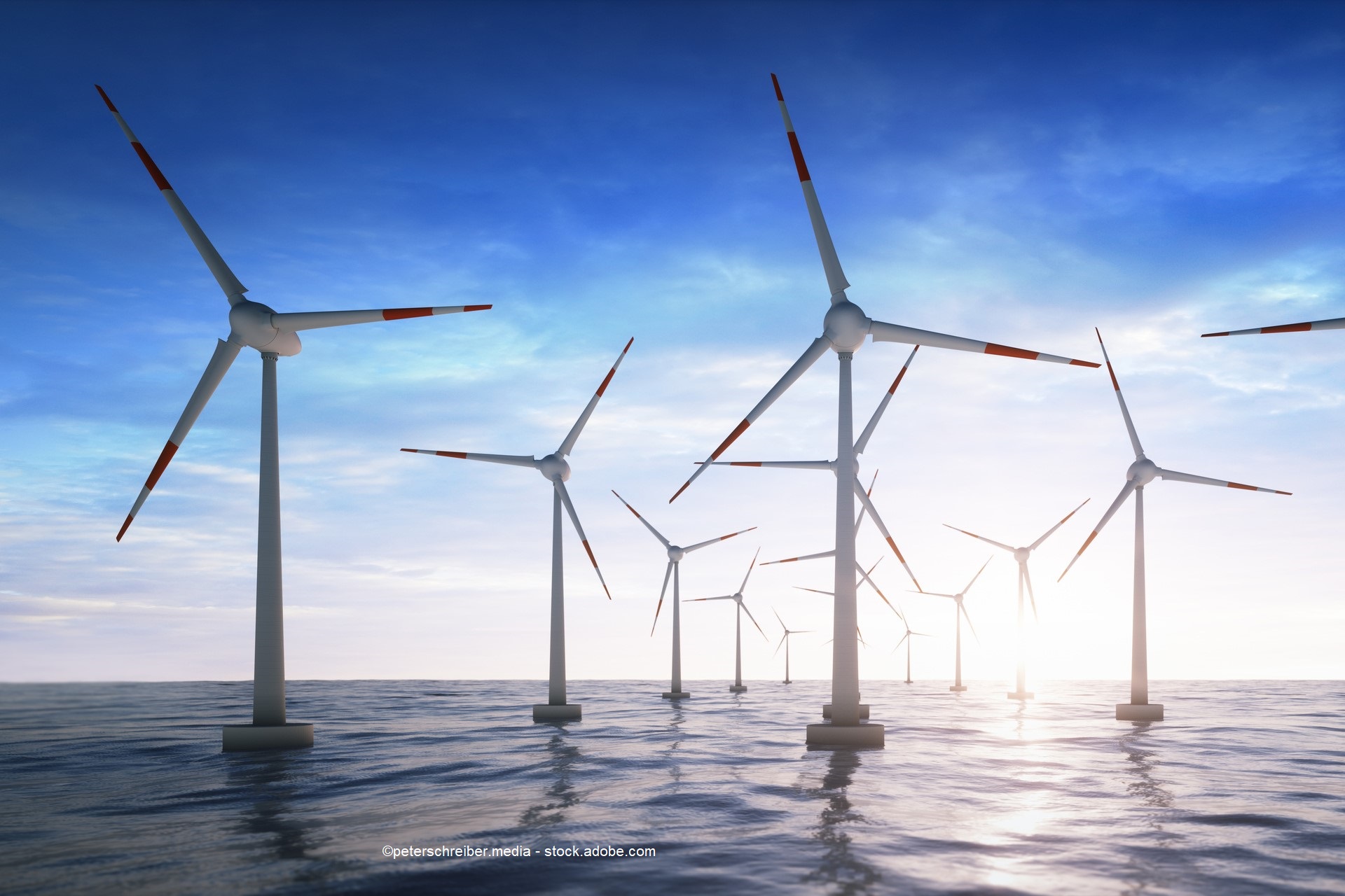 A field of wind turbines stands in calm waters, illuminated by a soft, bright sky. The turbines, with red and white striped blades, rotate gently in the breeze, symbolizing renewable energy and sustainability.