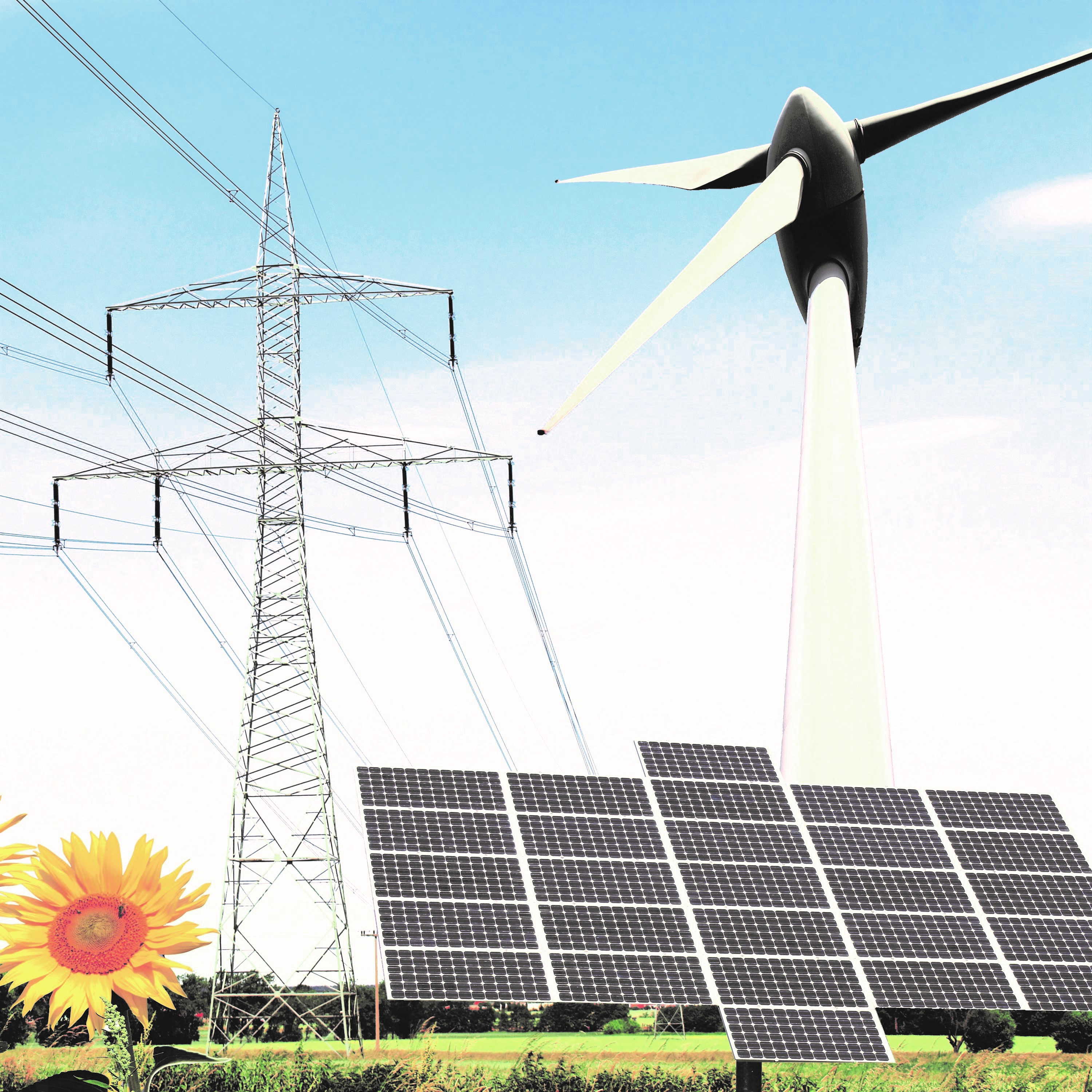 Eine Windkraftanlage steht neben einem Solarpark mit Photovoltaik-Modulen und einer Hochspannungsleitung. Im Vordergrund blüht eine Sonnenblume. Der Himmel ist hellblau, was die nachhaltige Energieproduktion betont.