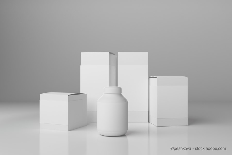 A collection of white product containers, including a cylindrical bottle at the front and several square boxes behind it, all set against a simple gray background. The monochromatic design emphasizes the shapes and forms of the packaging.