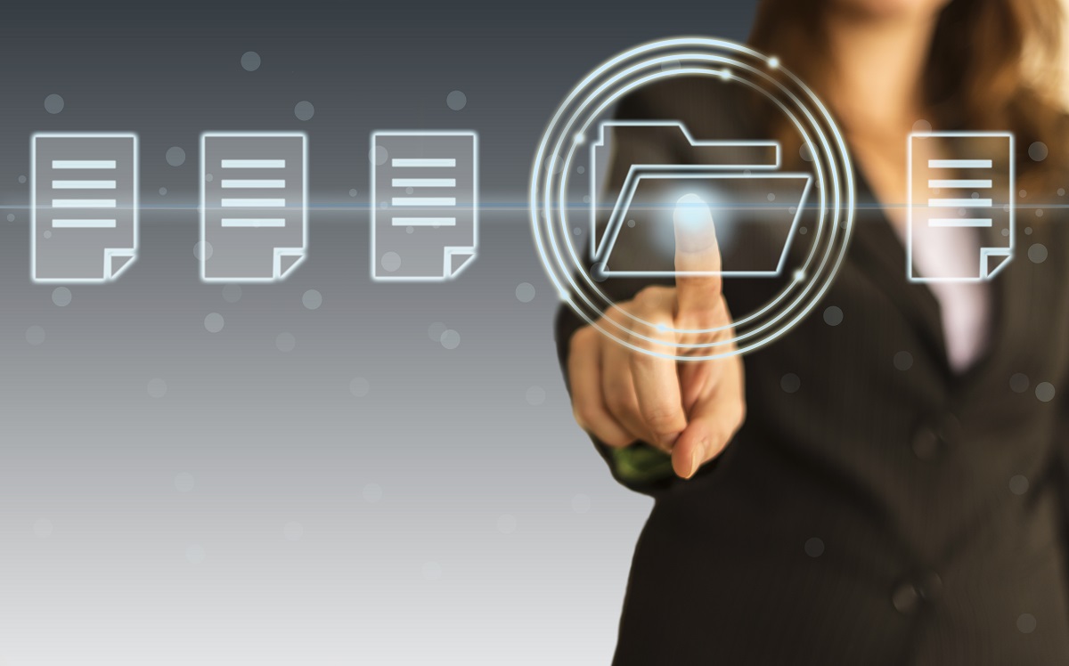 A business professional is touching a digital folder icon with their finger. Surrounding the icon are several stylized document illustrations, suggesting an electronic filing or organizing process. The background features a gradient, adding a modern technological feel to the scene.