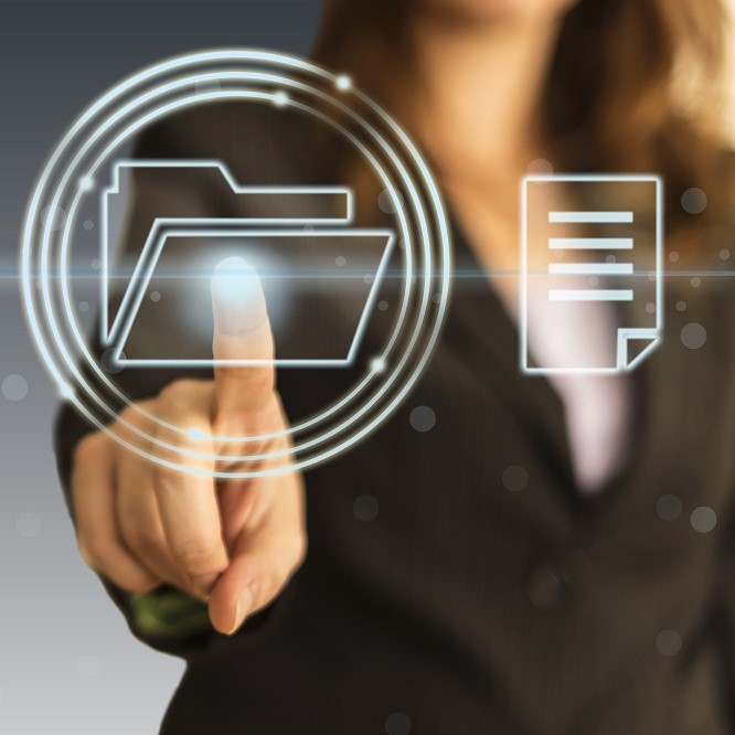 A person in business attire is interacting with a digital interface, pointing at a glowing folder icon and a document icon. The image conveys a sense of technology and digital file management.