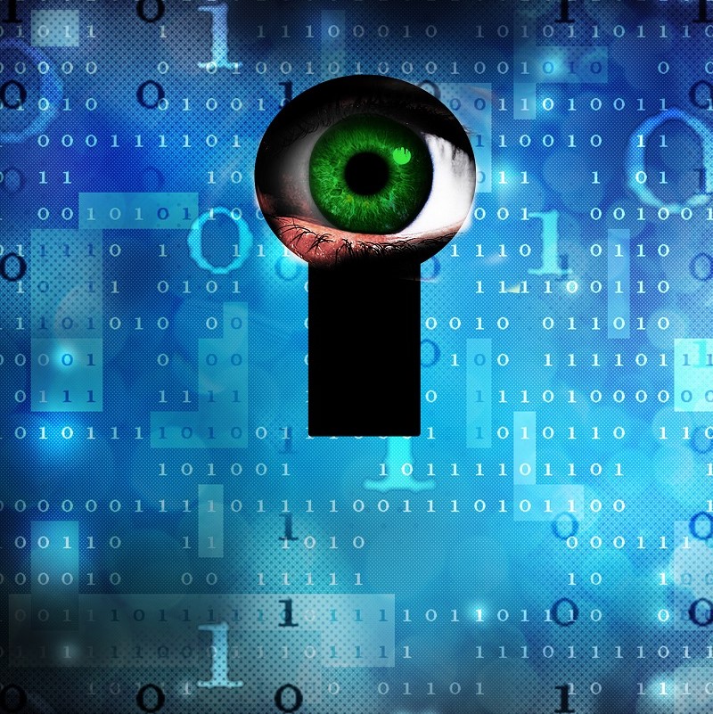 An eye with a vibrant green iris is seen through a keyhole, set against a blue background filled with binary code (1s and 0s). The image symbolizes surveillance or digital security, emphasizing the concept of observation and access.